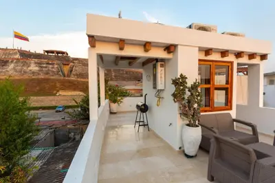 a small house with a balcony with a view at Casa Bali Castillo View Private Pool & Rooftop, Near Historic Center in Cartagena de Indias