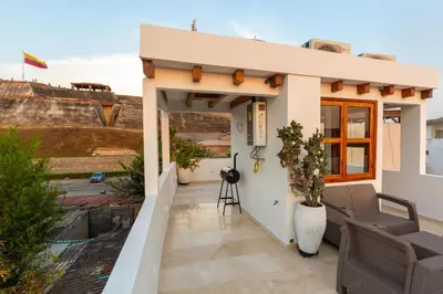 a small house with a balcony with a view at Casa Bali Castillo View Private Pool & Rooftop, Near Historic Center in Cartagena de Indias