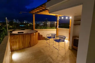 a balcony with two chairs and a bath tub at Blue House Castillo View Private Jacuzzi & Colonial Balconies in Cartagena de Indias