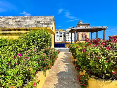 a garden with flowers inront of a building at Calamari Homes - El Porvenir 305 - Walled city in Cartagena de Indias