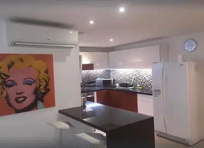 a kitchen with a painting of a woman on the wall at Vista Divisadero 25 in Cartagena de Indias