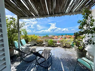 a patio with chairs and a view of the ocean at by Calamari Homes-Plaza Bolivar Penthouse Sea view in Cartagena de Indias
