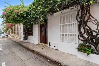 a white building with flowers on the side of a street at Reve hotel in Cartagena de Indias