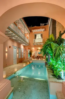 a swimming pool in a building with an arch over it at Upper Hotel in Cartagena de Indias