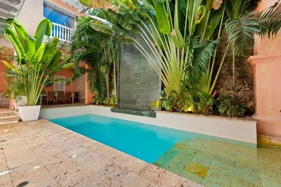 a swimming pool in a house with plants at Upper Hotel in Cartagena de Indias