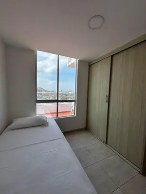 a bedroom with a bed and a large window at Apartamento amoblado, cómodo y cerca de lo mejor de la ciudad in Cartagena de Indias