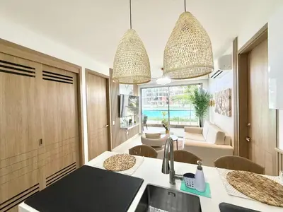 a kitchen with two pendant lights and a living room at Baia Krystal P4, 1A in Cartagena de Indias