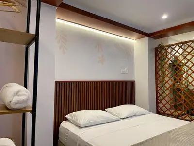 a bedroom with a bed with a wooden headboard at Almería Apt, Cozy Studio withTerrace Near Old Town in Cartagena de Indias