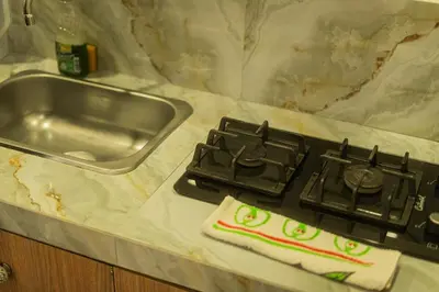 a kitchen counter with a stove and a sink at Almería Apt, Cozy Studio withTerrace Near Old Town in Cartagena de Indias