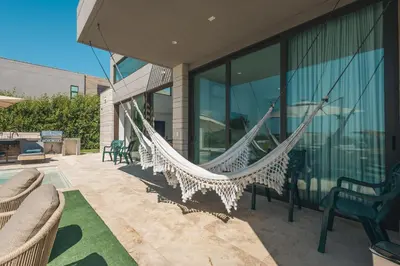 a hammock on the patio of a house at 4BR Caribbean Deluxe Villa 3C in Cartagena de Indias