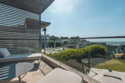 a balcony with chairs and tables and a view of the ocean at 4BR Caribbean Deluxe Villa 3C in Cartagena de Indias