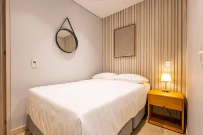 a bedroom with a large white bed and a mirror at 4BR Seaview Apartment at Calablanca D5 in Cartagena de Indias