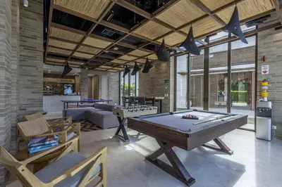 a living room with a pool table and chairs at 4BR Seaview Apartment at Calablanca D5 in Cartagena de Indias