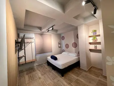 a bedroom with a bed and a staircase in it at Almería Apt, Spacious Studio Near Old Town in Cartagena de Indias