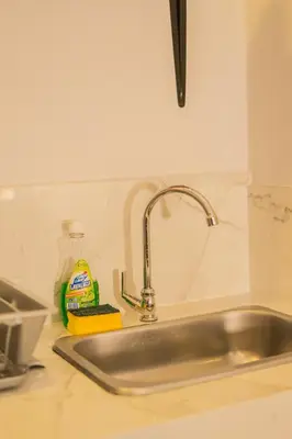 a kitchen sink with a detergent and a bottle of detergent at Almería Apt, Stylish Modern Studio Near Centro in Cartagena de Indias
