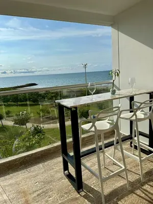 a table and chairs with a view of the ocean at Cartagena Beach - Sea View - Airport 5 min in Cartagena de Indias