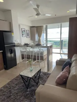 a living room and kitchen with a couch and a table at Cartagena Beach - Sea View - Airport 5 min in Cartagena de Indias