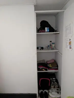 a closet with shoes and other items on shelves at English power Exotic point in Barranquilla