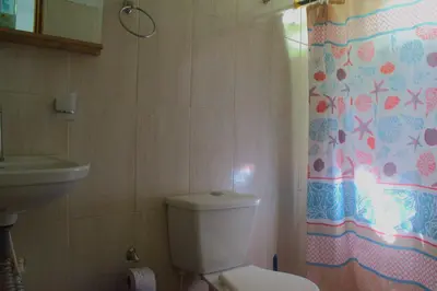 a bathroom with a toilet and a sink at Mango Tree Island 420 in Tierra Bomba