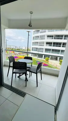 a balcony with a table and chairs and a building at Apartamento cómodo en Conjunto residencial Castelo Cartagena in Cartagena de Indias