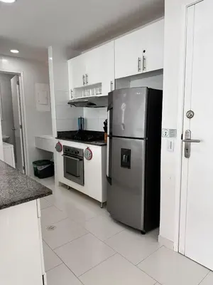a kitchen with a stainless steel refrigerator and white cabinets at Exclusivo Apartamento con playa y piscinas Morros Cartagena in Cartagena de Indias