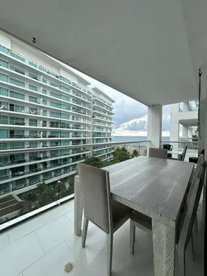 a dining room with a table and chairs and a large window at Exclusivo Apartamento con playa y piscinas Morros Cartagena in Cartagena de Indias
