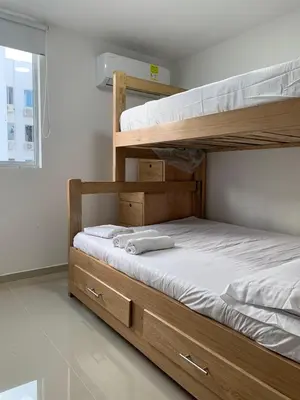 a bedroom with two bunk beds and a window at Prada Caribe 303 in Coveñas