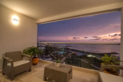 a living room with a large window with a view of the ocean at Sea View Modern Loft in Cartagena de Indias