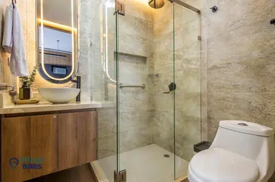 a bathroom with a toilet and a glass shower at Beach Front - Luxury High Rise - Dubai Style in Cartagena de Indias