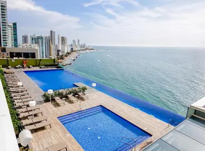 an overhead view of a swimming pool and the ocean at luxury Aparment Ocean view H2 condominium apto 2105 in Cartagena de Indias