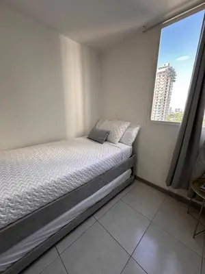 a small bed in a room with a window at Apartment in Cartagena Sea View & Ocean View Cerca al centro Histórico in Cartagena de Indias