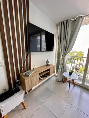 a living room with a flat screen tv on the wall at Apartment in Cartagena Sea View & Ocean View Cerca al centro Histórico in Cartagena de Indias