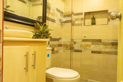 a bathroom with a toilet and a glass shower at Inca Caribe 302 in Coveñas