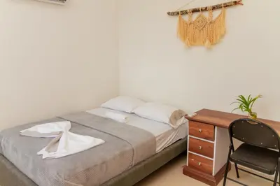 a bedroom with a bed and a desk and a chair at Raíces Caribe 503 in Coveñas