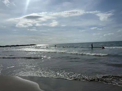 a group of people in the water at the beach at ÁME Living in Cartagena de Indias