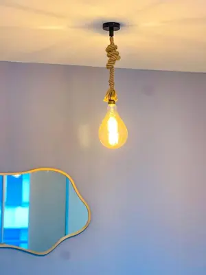 a light hanging from a ceiling in a room at Cielo Caribe 501 in Coveñas