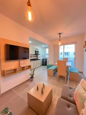 a living room with a couch and a tv at Cielo Caribe 501 in Coveñas