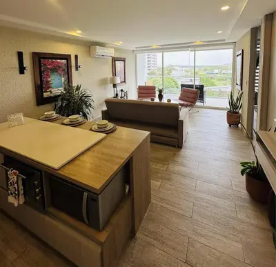 a large living room with a couch and a table at 1 bedroom luxury apartment with private jaccuzi in Cartagena de Indias