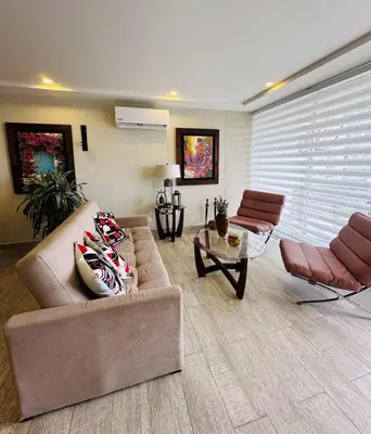 a living room with a couch and a table at 1 bedroom luxury apartment with private jaccuzi in Cartagena de Indias