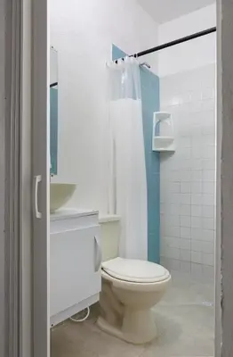 a bathroom with a toilet and a sink and a shower at Hotel Villa Ivel in Turbaco