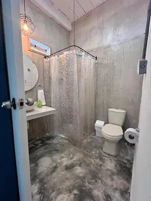 a bathroom with a shower and a toilet and a sink at Calma Hospedaje in Turbaco