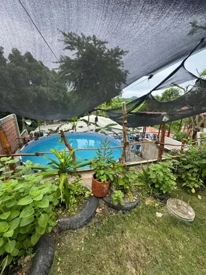 a swimming pool in a tent with some plants at Casa Campestre DONDE MAMI ENA in Galapa