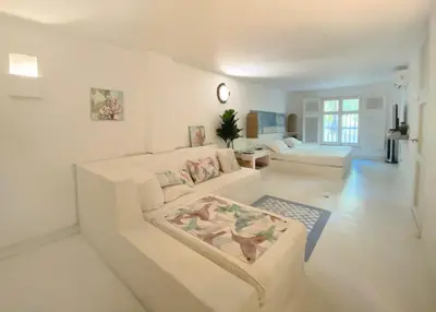 a white living room with a couch and a table at Apartment in the Historical Center of Cartagena in Cartagena de Indias