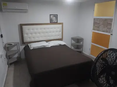 a bedroom with a bed with two pillows on it at Alojamiento independiente, sencillo y acogedor in Barranquilla