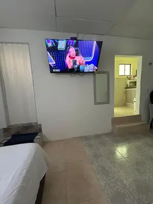 a room with a tv on a wall with a bed at acogedor aparta estudio in Cartagena de Indias
