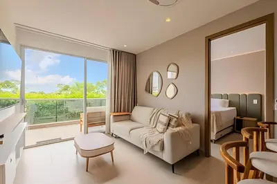 a living room with a couch and a bedroom at 1 k Baia Kristal lujoso y nuevo 2 alcobas Prive 2 in Cartagena de Indias