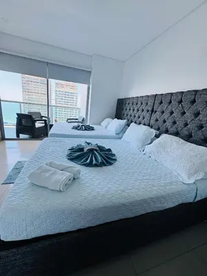 a bedroom with two beds with towels on them at Vista Preciosa desde el piso 23 Apartamento frente al mar in Cartagena de Indias