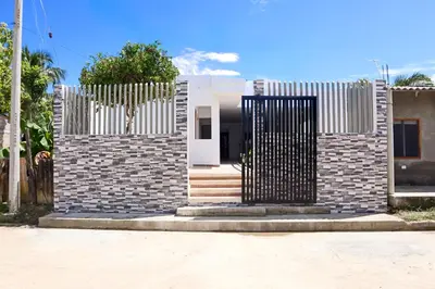 a house with a gate in front of it at Habitación Manglares 102 in Coveñas
