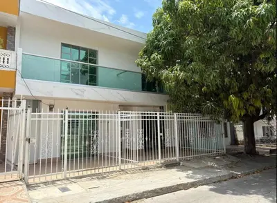 a white fence in front of a building at Maru Apartamentos #4 in Cartagena de Indias