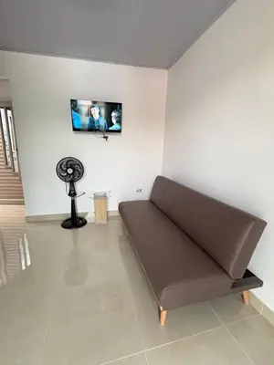 a living room with a couch and a tv on the wall at Maru Apartamentos #4 in Cartagena de Indias
